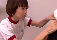Young oriental schoolgirl blowing teacher